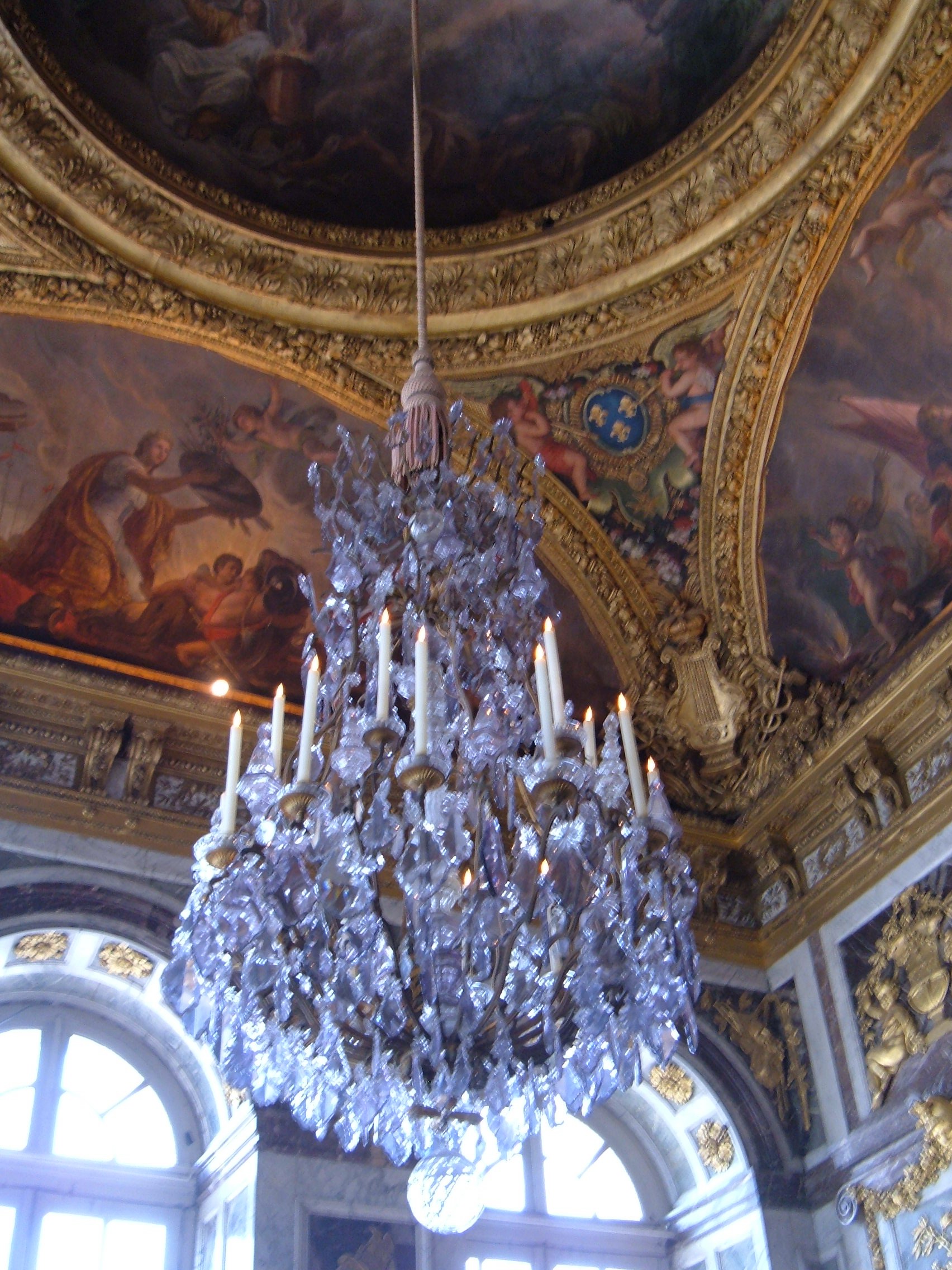 Crystal chandelier in a gilded hall